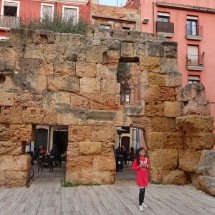 Girl with Roman ruins in Tarragona